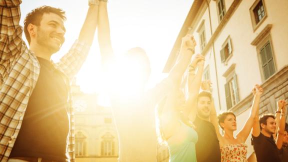 People smiling and holding hands